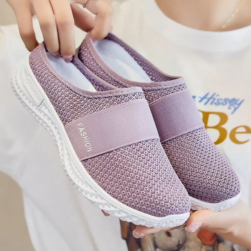 Women's breathable mesh casual shoes with flat heel and hollow-out design in black, grey, pink, or purple.