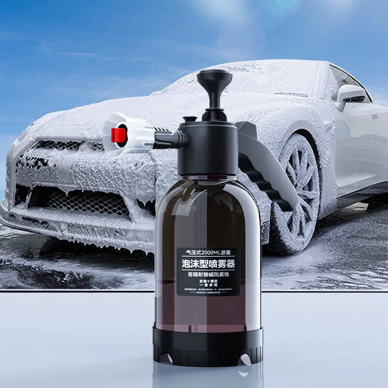 Black hand-held pressure sprayer with 2-litre capacity and two nozzles for garden and car cleaning