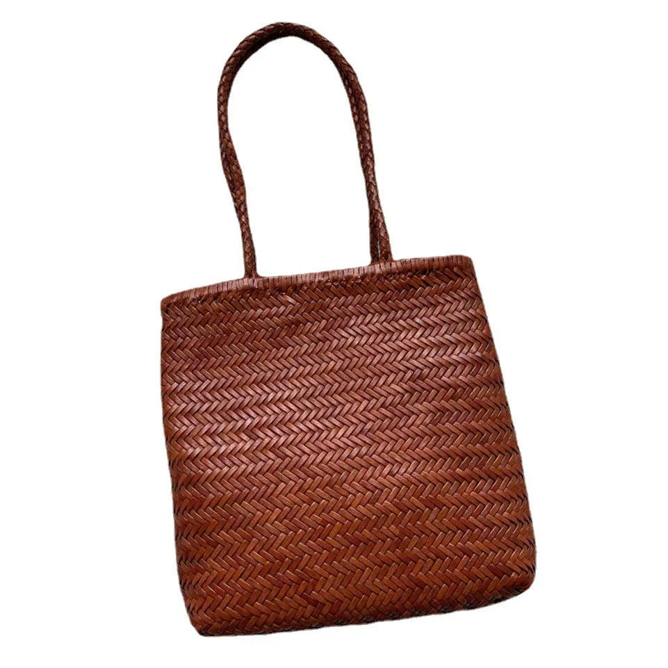 Brown handmade woven leather tote bag with a three-dimensional pocket.