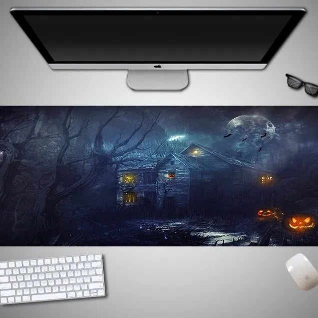 Large Halloween patterned gaming mouse pad on a desk showing non-slip rubber base and extra-long design.