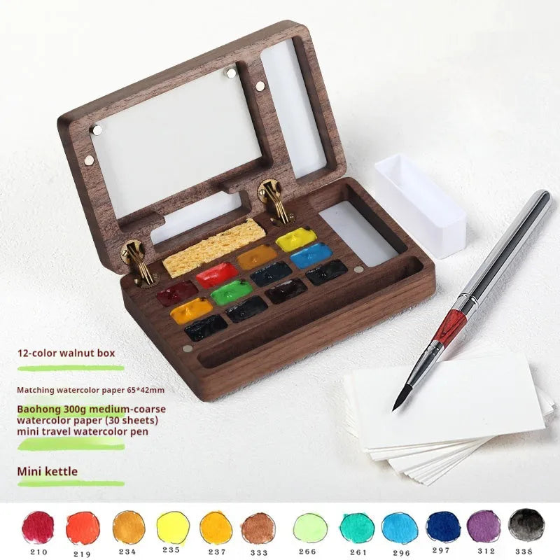 Mini wooden watercolour paint box with walnut finish, open to show pigment suit selection.