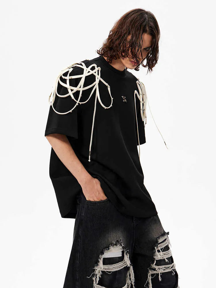 Black loose fit short-sleeved T-shirt with padded shoulders featuring rivet and ribbon detail.