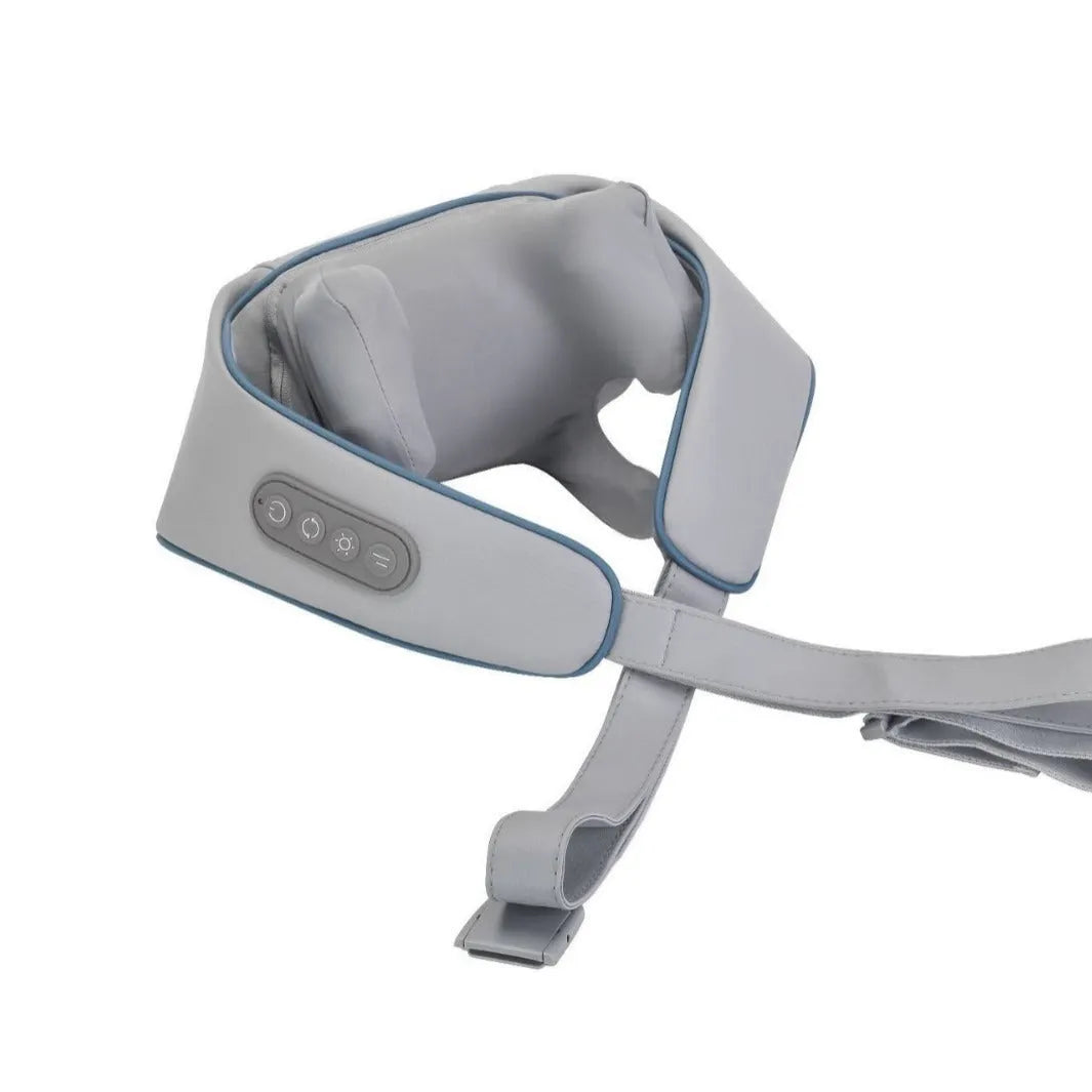 Beige neck massage pillow with six massage heads and wireless remote control on a table