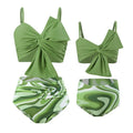 Women's big bow print bikini swim trunks set in bright colours on a mannequin.