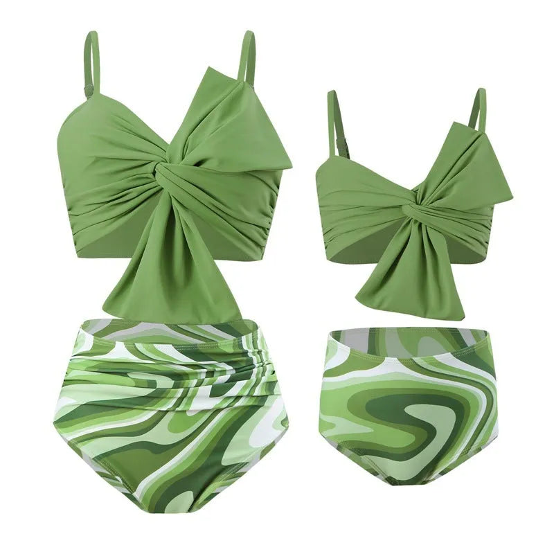 Women's big bow print bikini swim trunks set in bright colours on a mannequin.