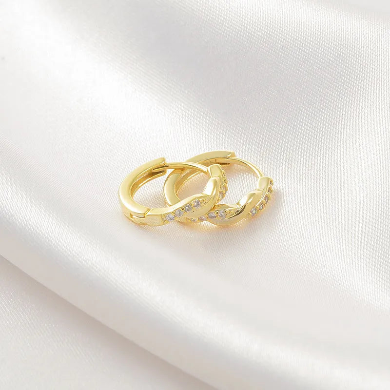 Women's gold geometric clip-on earrings with an interwoven hemp rope design.