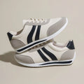 Blue and red low-top lace-up running sneakers with rubber soles and mesh upper