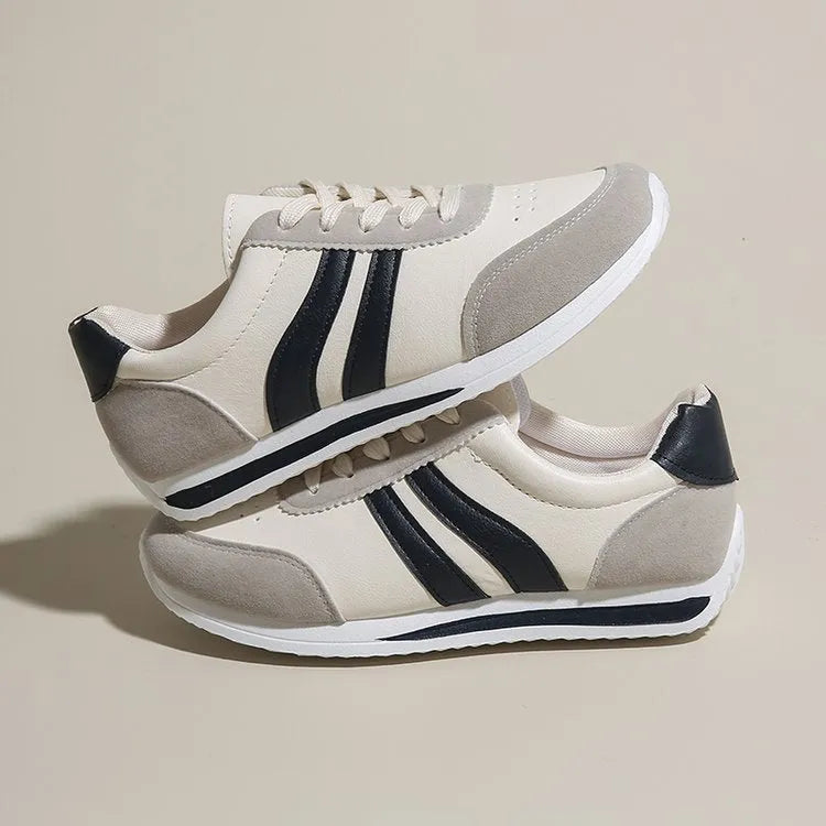 Blue and red low-top lace-up running sneakers with rubber soles and mesh upper