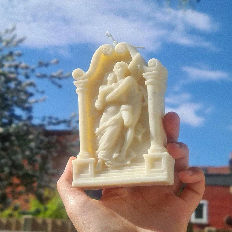 Flexible food-grade silicone mold for making hug angel couple figurines from wax, chocolate, or plaster.