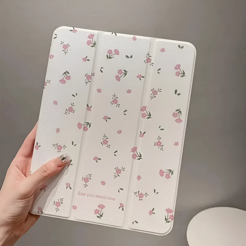 Transparent tri-fold Apple iPad case with cartoon floral print showing magnetic stand function.