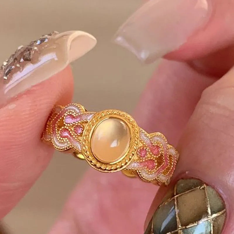 Geometric open ring for women in gold-plated copper with a pink crystal enamel detail.