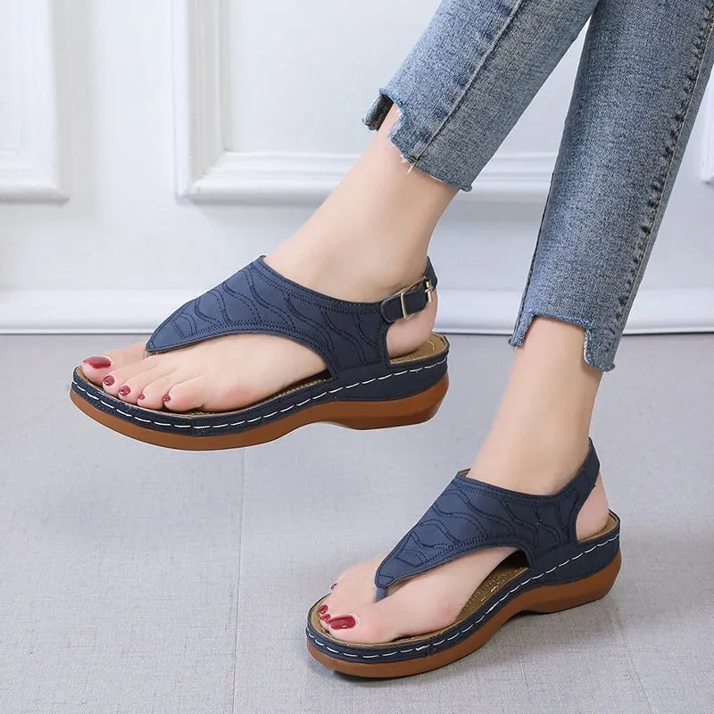 Women's black casual wedge heel flip flop sandals with an adjustable buckle strap.