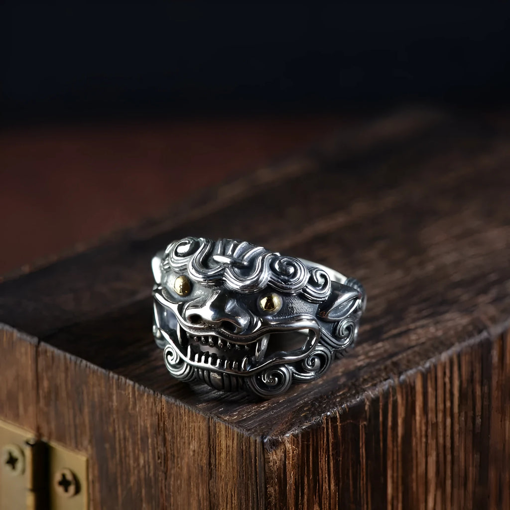 Silver open-ended ring with a raised Domineering Jibeast animal zodiac pattern.
