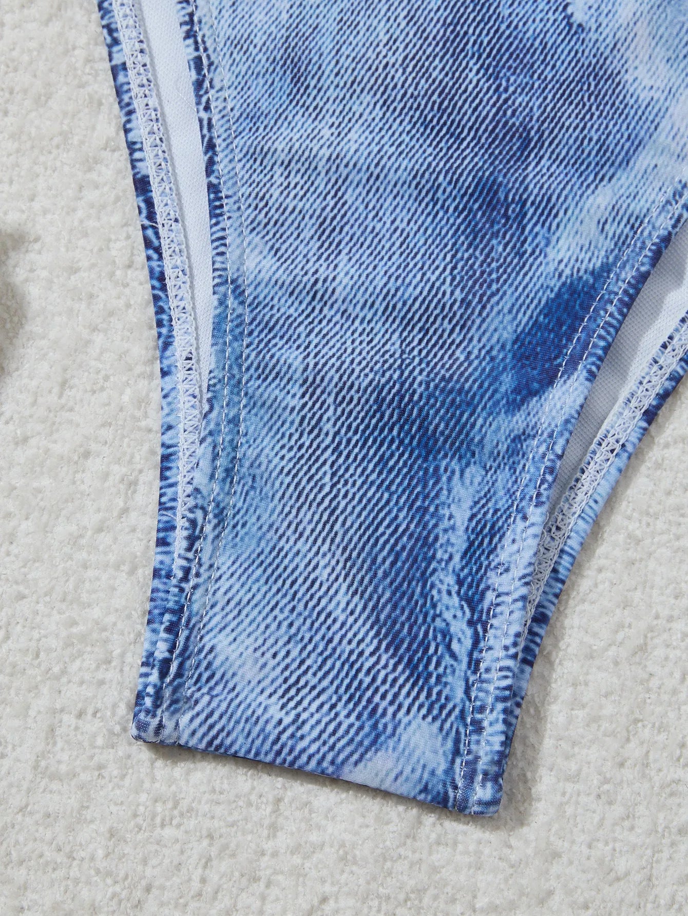 Women's denim blue printed bikini set with strap detail, made from nylon spandex fabric.