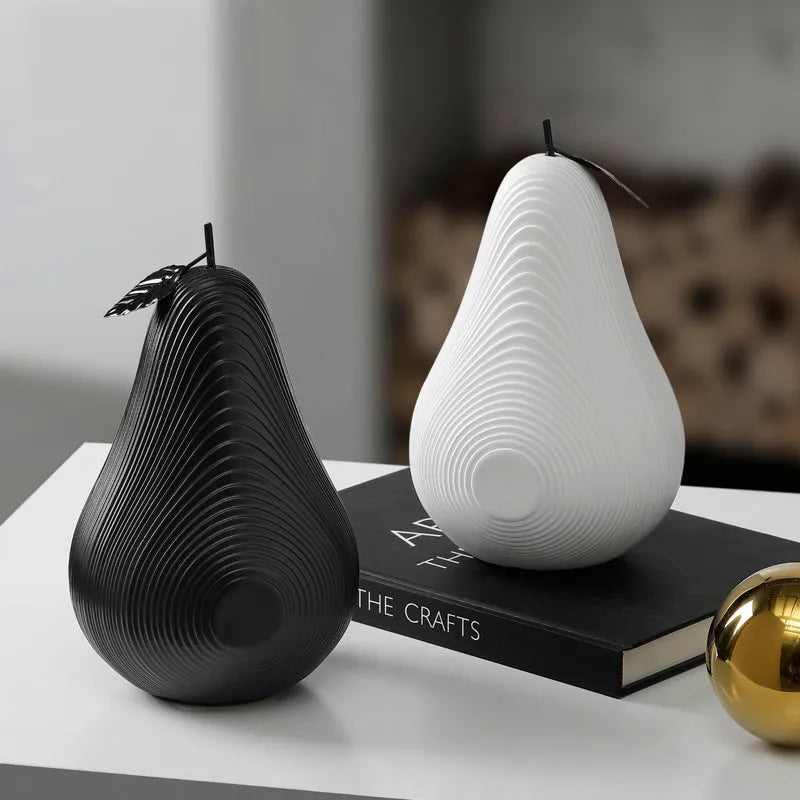 Resin apple and pear ornaments, black high model 17cm by 14cm and white low model 16cm by 12cm.