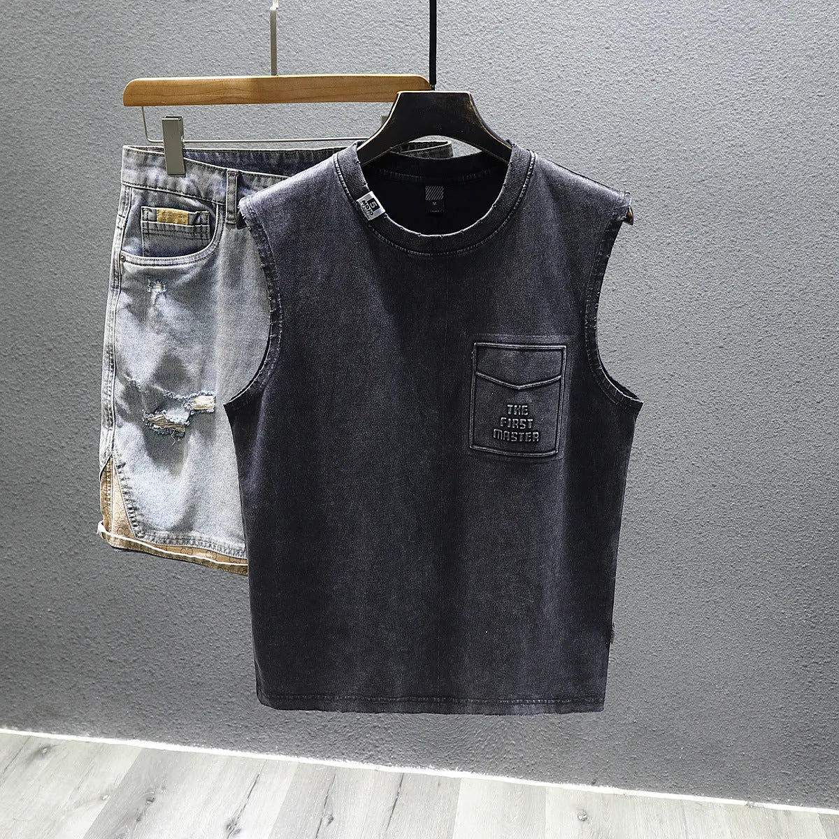 A solid colour loose-fitting cotton sleeveless T-shirt with a straight hem, shown in white.