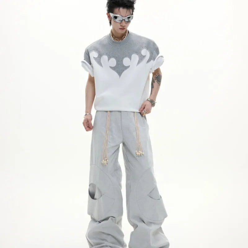 Grey men's T-shirt with raised black floral embroidery and rhinestone details on a dropped shoulder, loose-fit design.