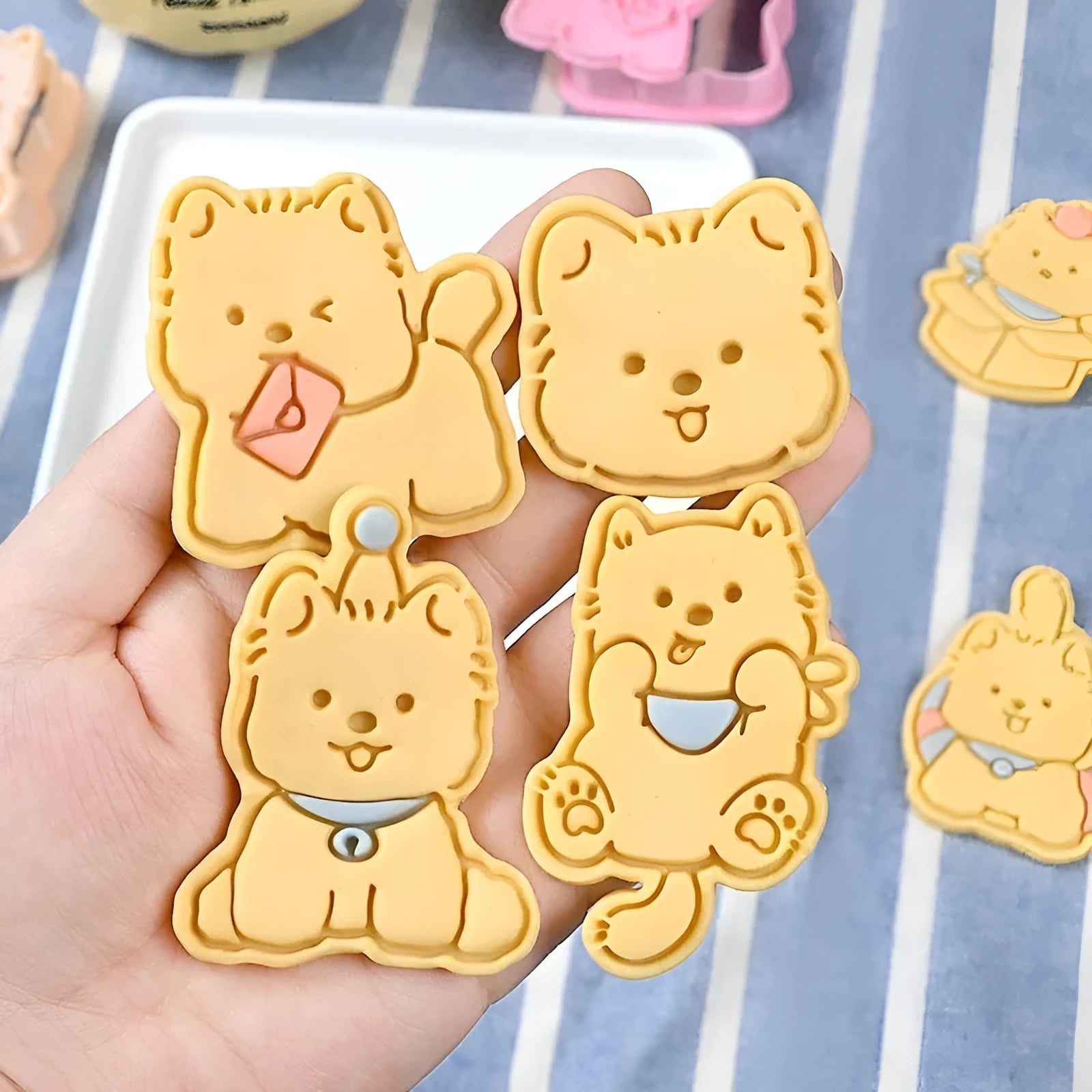 Three-dimensional plastic biscuit mould set with puppy cartoon designs including birthday hats and swimming rings