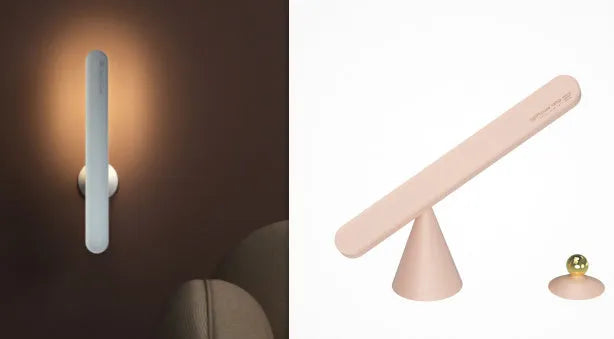White geometric desk lamp with magnetic base mounted on a metal wall surface.