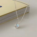 Women's silver necklace with a geometric stone pendant on a curb chain.