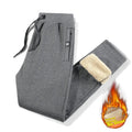 Men's grey fleece-lined oversized track pants with elastic waistband