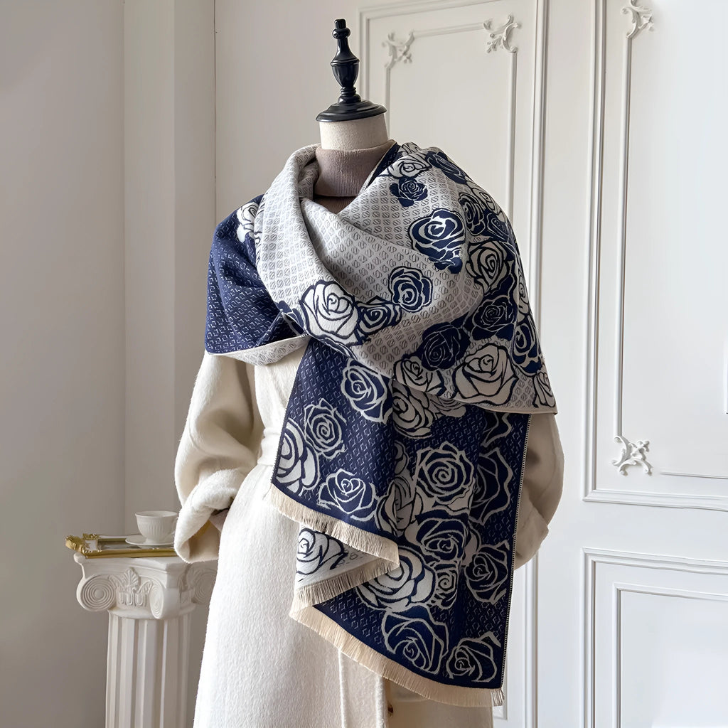 Long grey imitation cashmere winter scarf with tassel fringe on a neutral background.