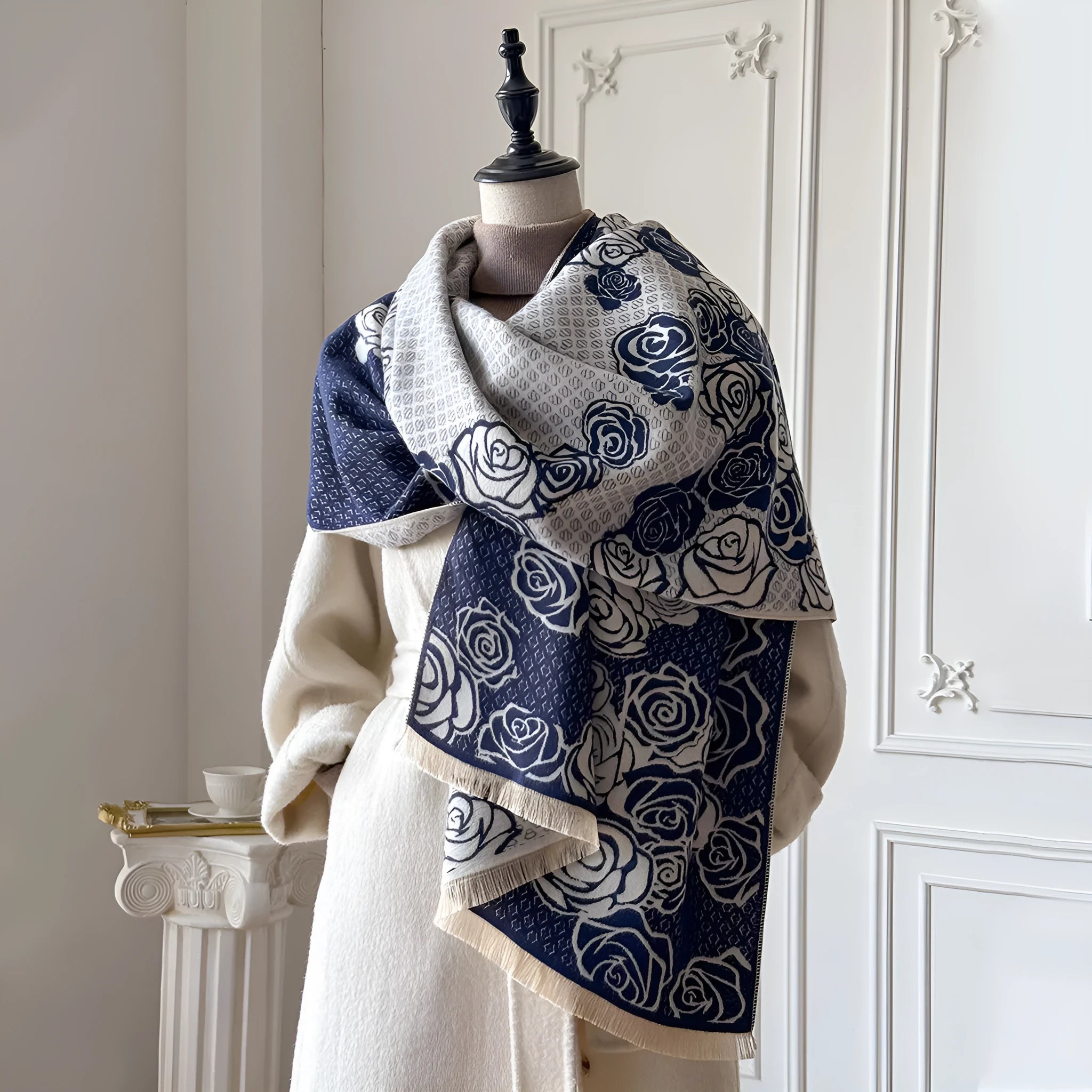 Long grey imitation cashmere winter scarf with tassel fringe on a neutral background.