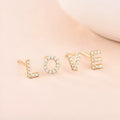 Gold plated copper stud earrings showing a single English letter, part of a full alphabet set.