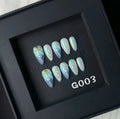 Set of blue plastic shell-shaped nail stickers in sizes XS, S, M, and L