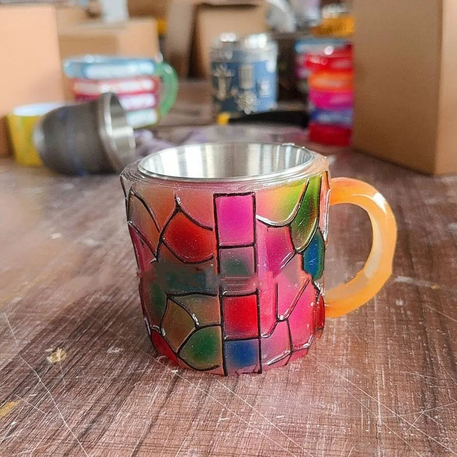 Painted synthetic resin coffee cup bookmark ornament in library style on a wooden shelf.