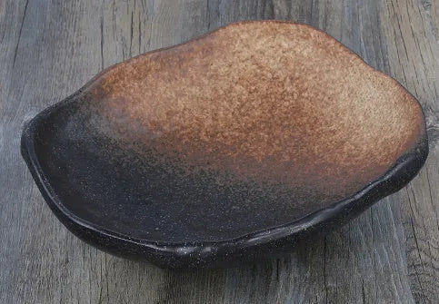 Creative ceramic Japanese-style irregular shaped bowl with floral decoration and sauce dish