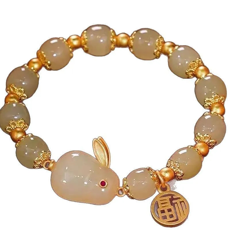 Manual crafted glass and coloured glaze bracelet with rabbit charm and silver peace buckle clasp on wrist.