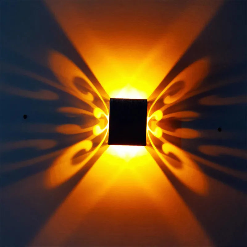 Modern aluminium butterfly-shaped LED wall lamp with remote control for seven colour options.
