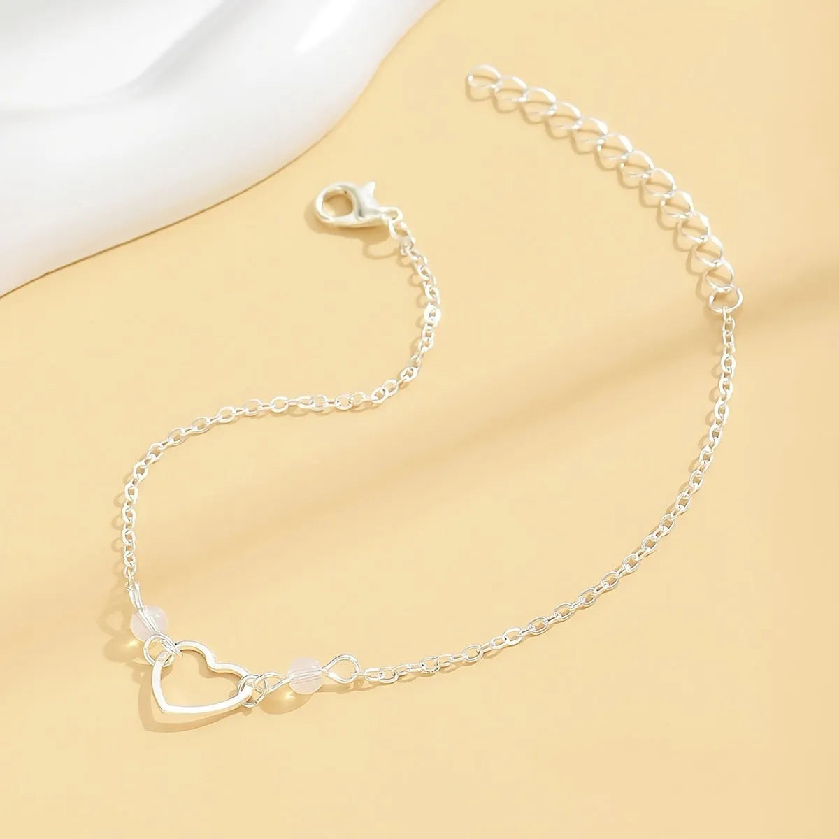 Women's adjustable anklet with heart pendant in gold and silver colours