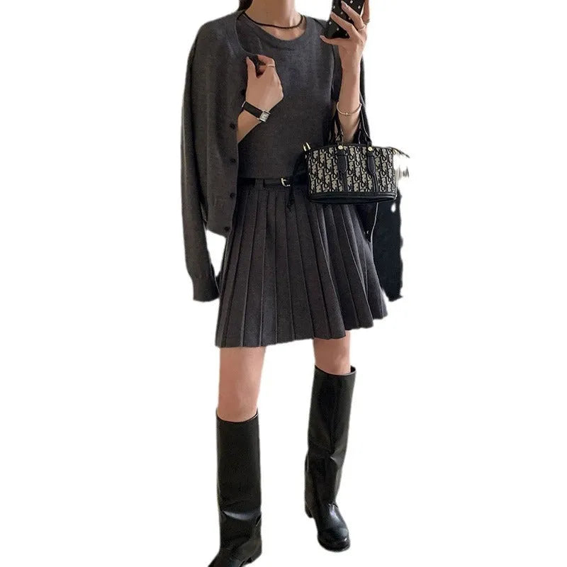 Grey art retro knitted two-piece set with 3D pattern, featuring a pleated vest skirt with belt and a V-neck long-sleeve cardigan.