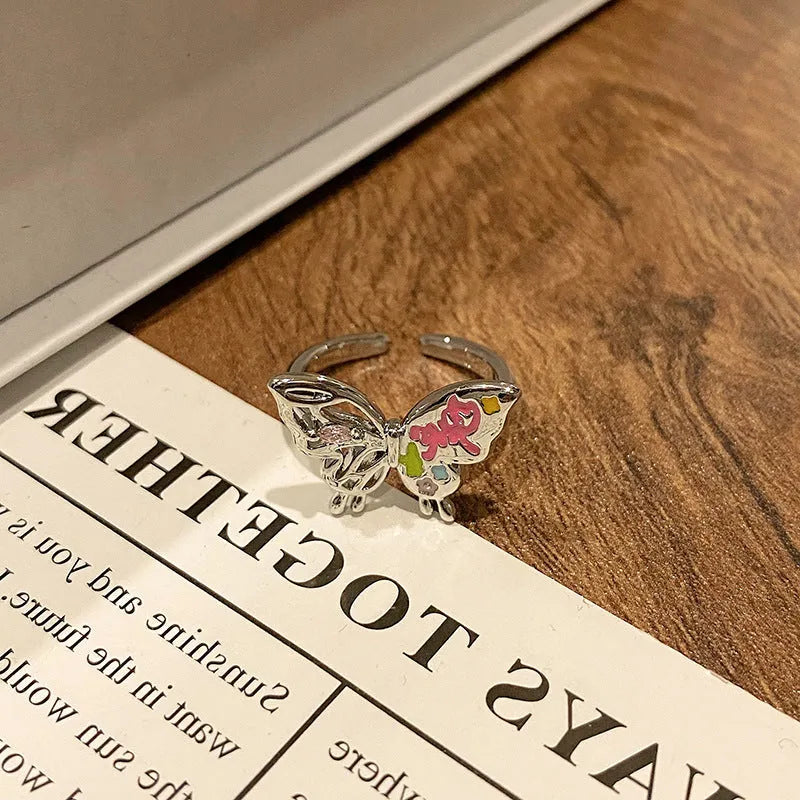 Creative butterfly design women's ring in copper with oil drip finish, showing an open loop style.
