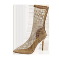 Gold high heel sandals with pointed toes, stiletto heels, and a mesh upper.