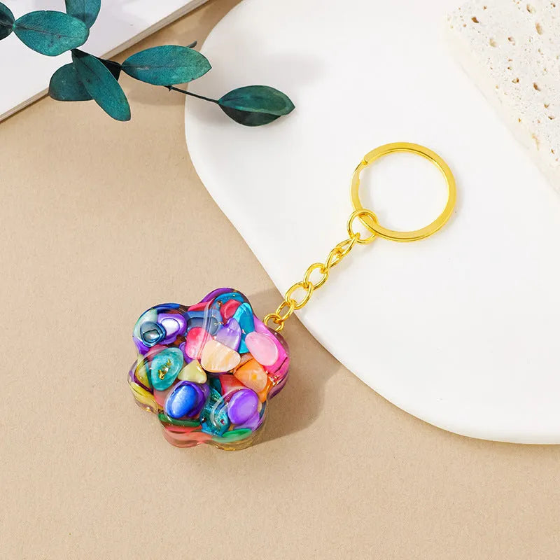 Hand-finished natural crystal cat's paw keychain pendant on a metal ring, showing detailed carving and polished stone surface.