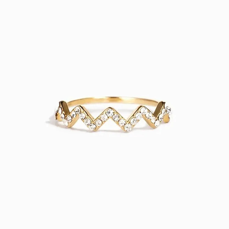 Sterling silver wave pattern adjustable ring with gem inlay, gold colour, against neutral background