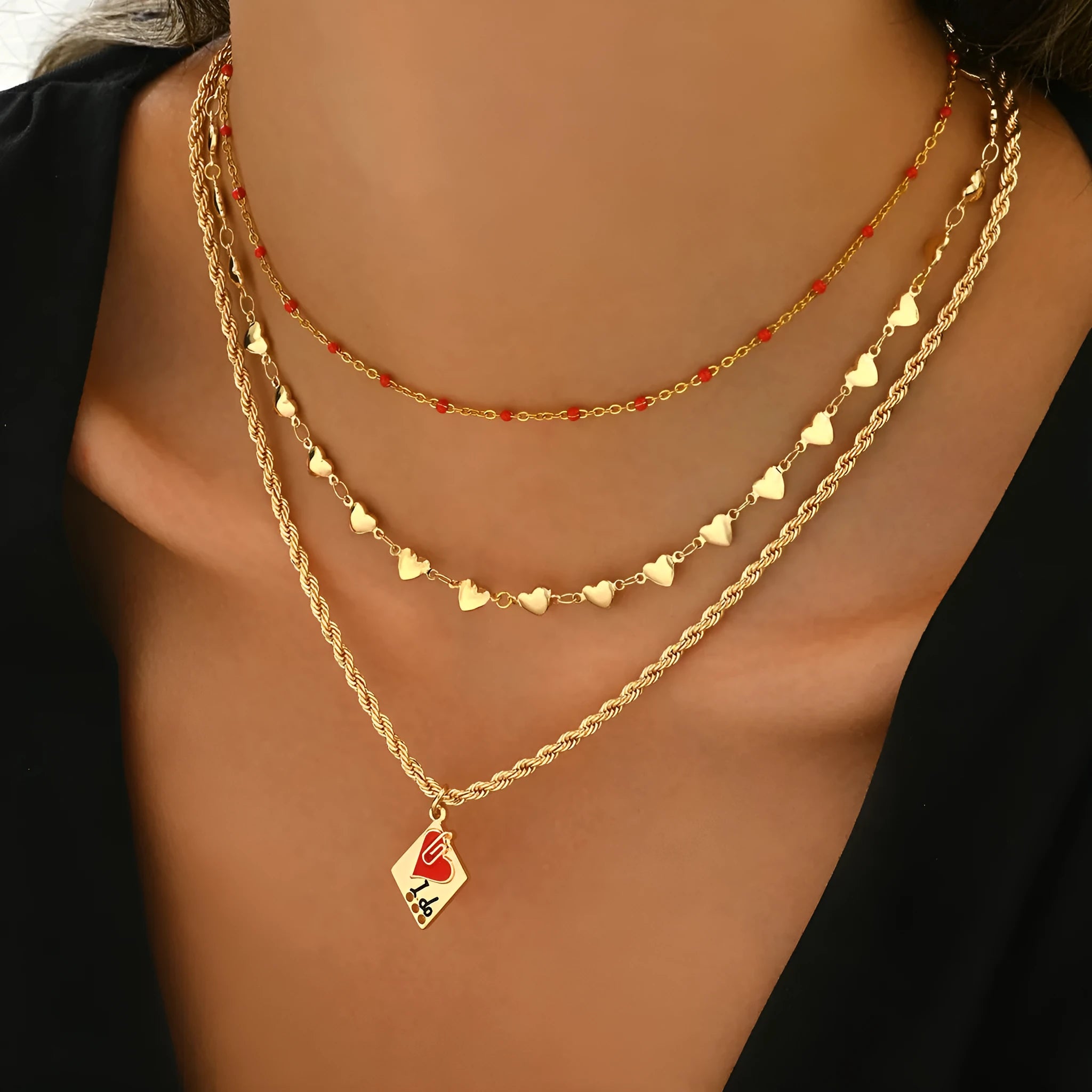 Close-up of a zinc alloy heart pendant on an adjustable three-layer clavicle chain necklace.