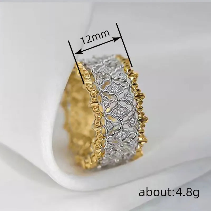 A geometric two-tone gold zircon ring on a hand, showing its round design and copper construction.