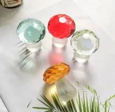 Solid resin crystal mushroom decoration in light green on a wooden surface