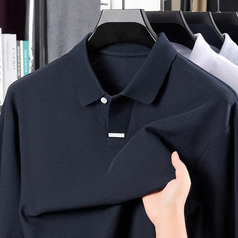Man modelling a grey loose-fit cotton polo shirt with a lapel collar and asymmetric design.