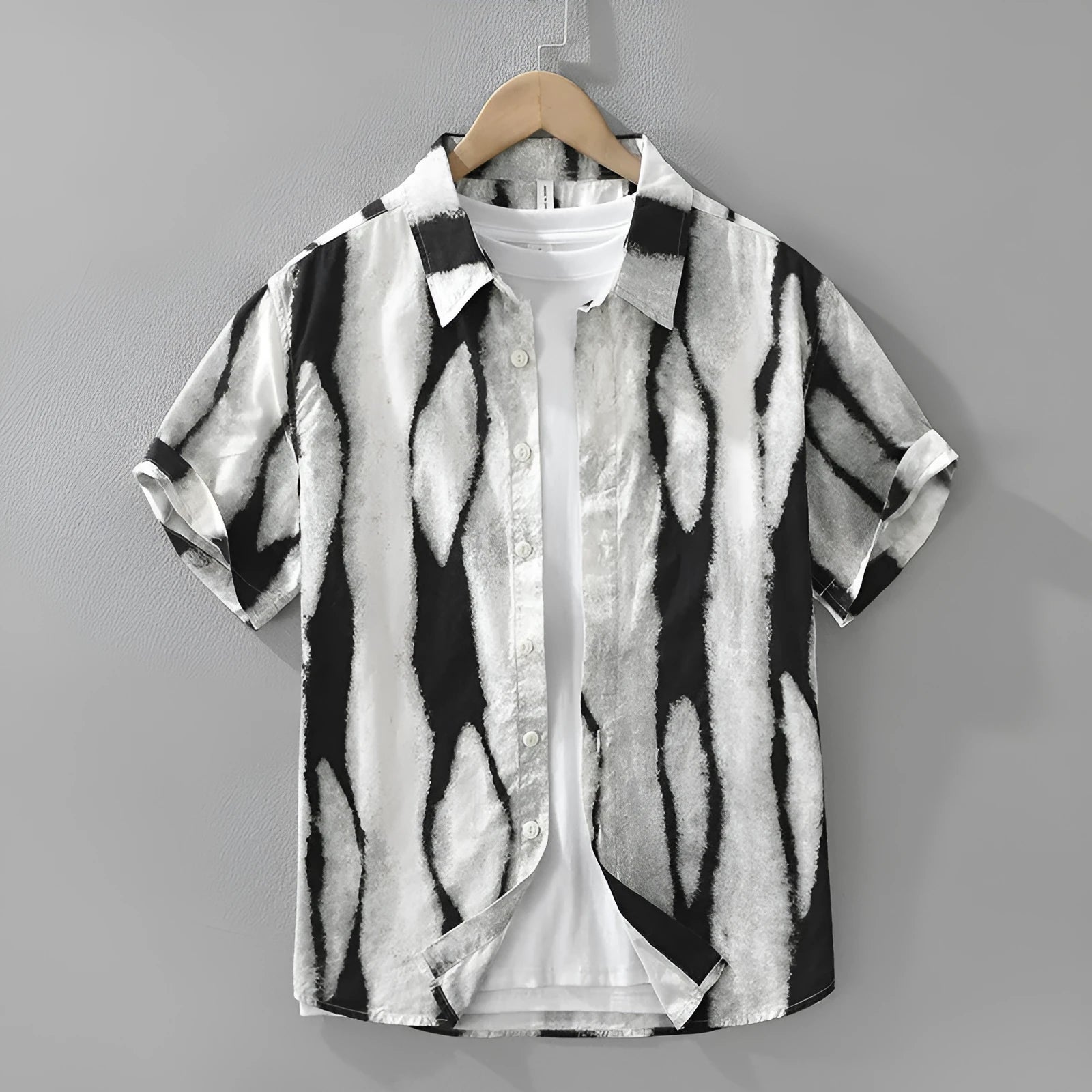 Man wearing a black and white striped retro-style short sleeve cotton shirt with a loose cardigan fit.
