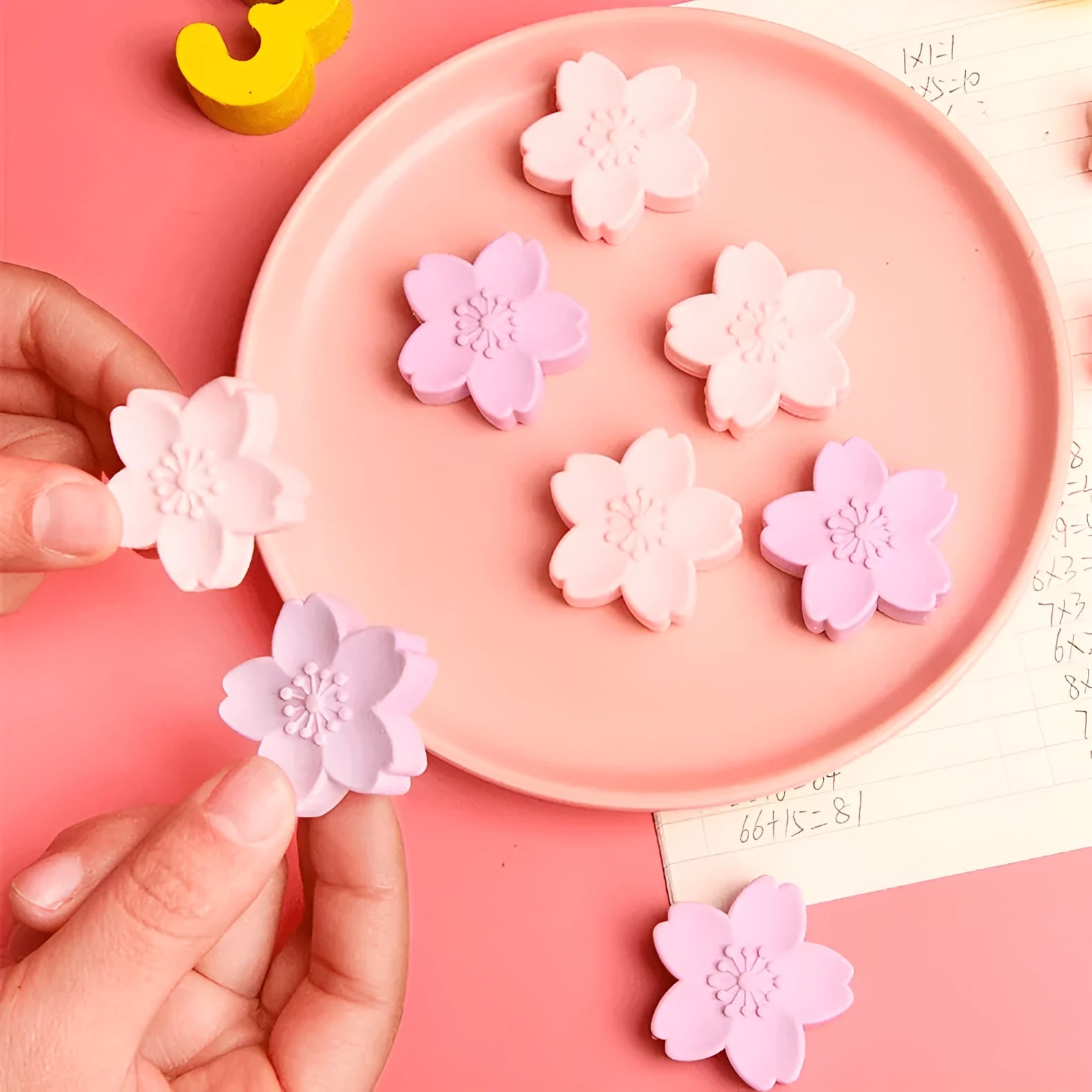 Assortment of cherry blossom decorated erasers in various colours from a bulk pack.