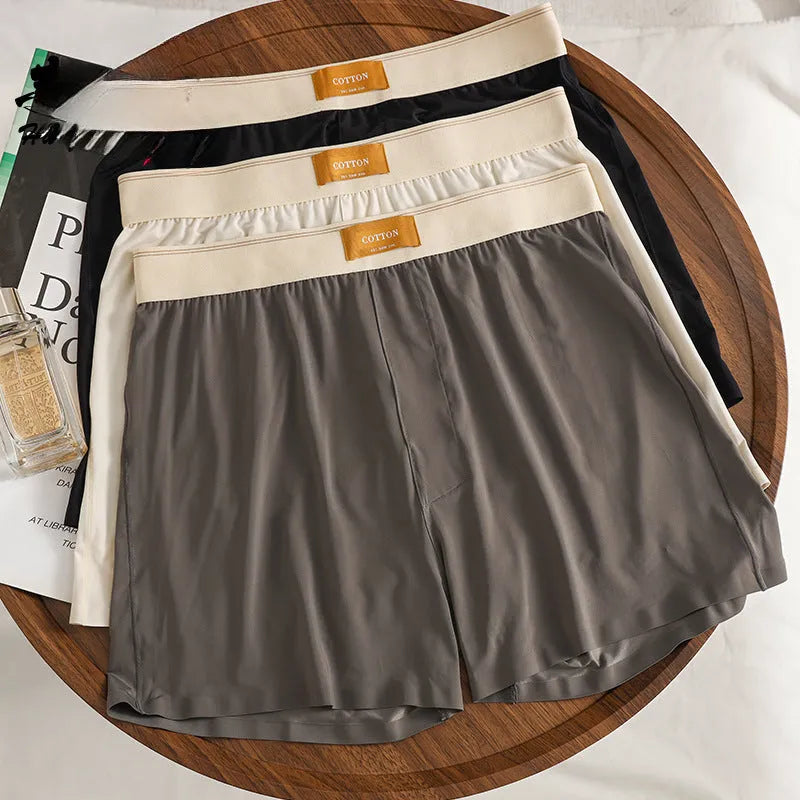 Men's solid colour ice silk underwear with a loose fit and mid waistband on a neutral background.