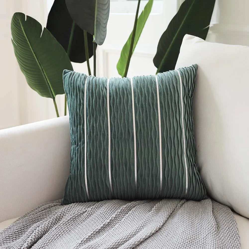 Square striped velvet pillow cover for sofa in multiple colour options on a grey background.