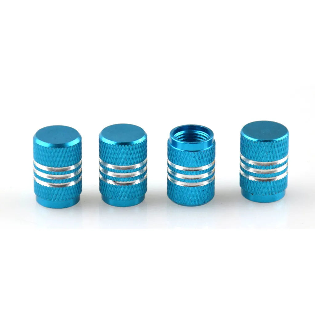Assortment of aluminium alloy car tyre valve caps in ten different colours on a grey background.