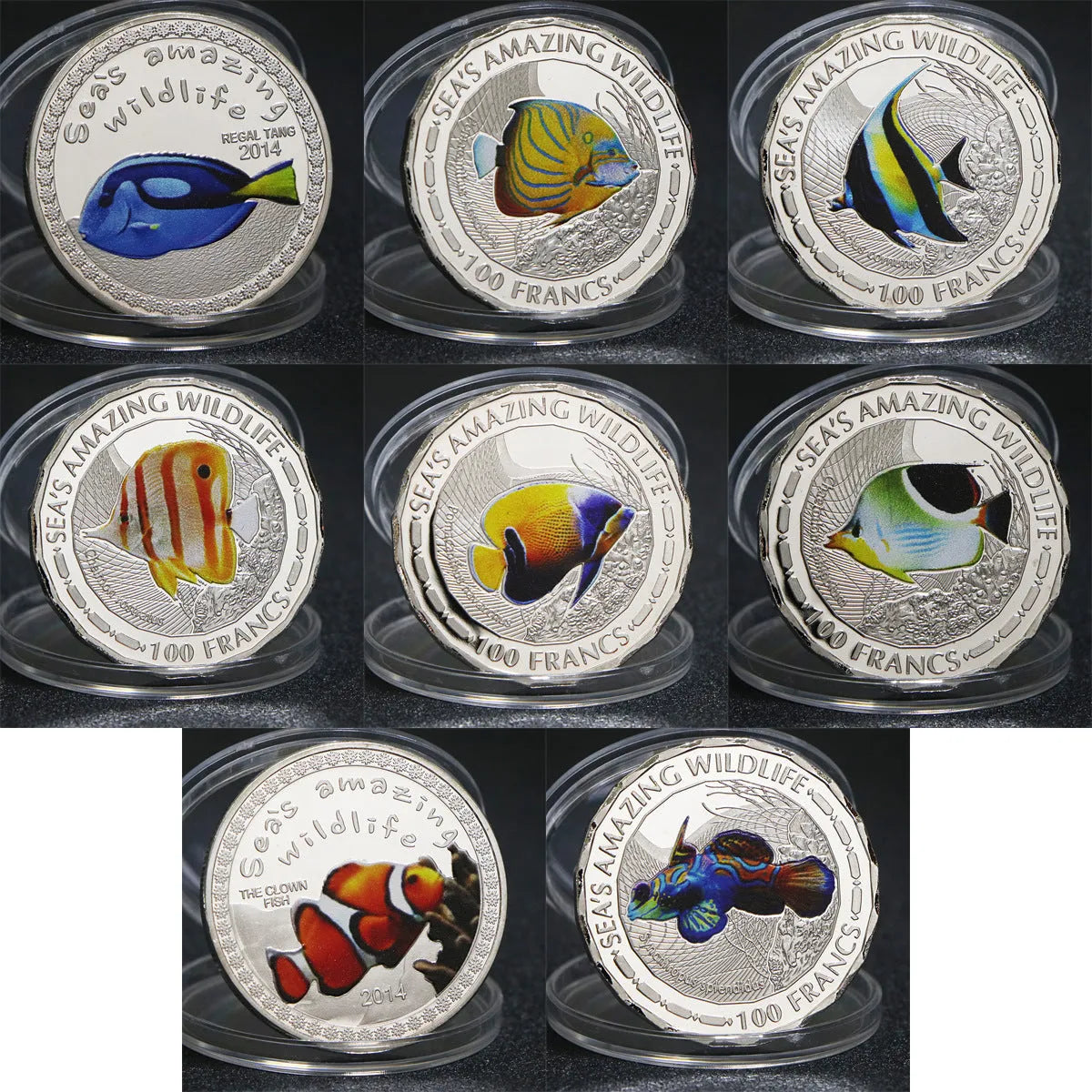 Set of eight silver plated commemorative coins with tropical fish and marine animal designs, 40mm diameter, in acrylic box