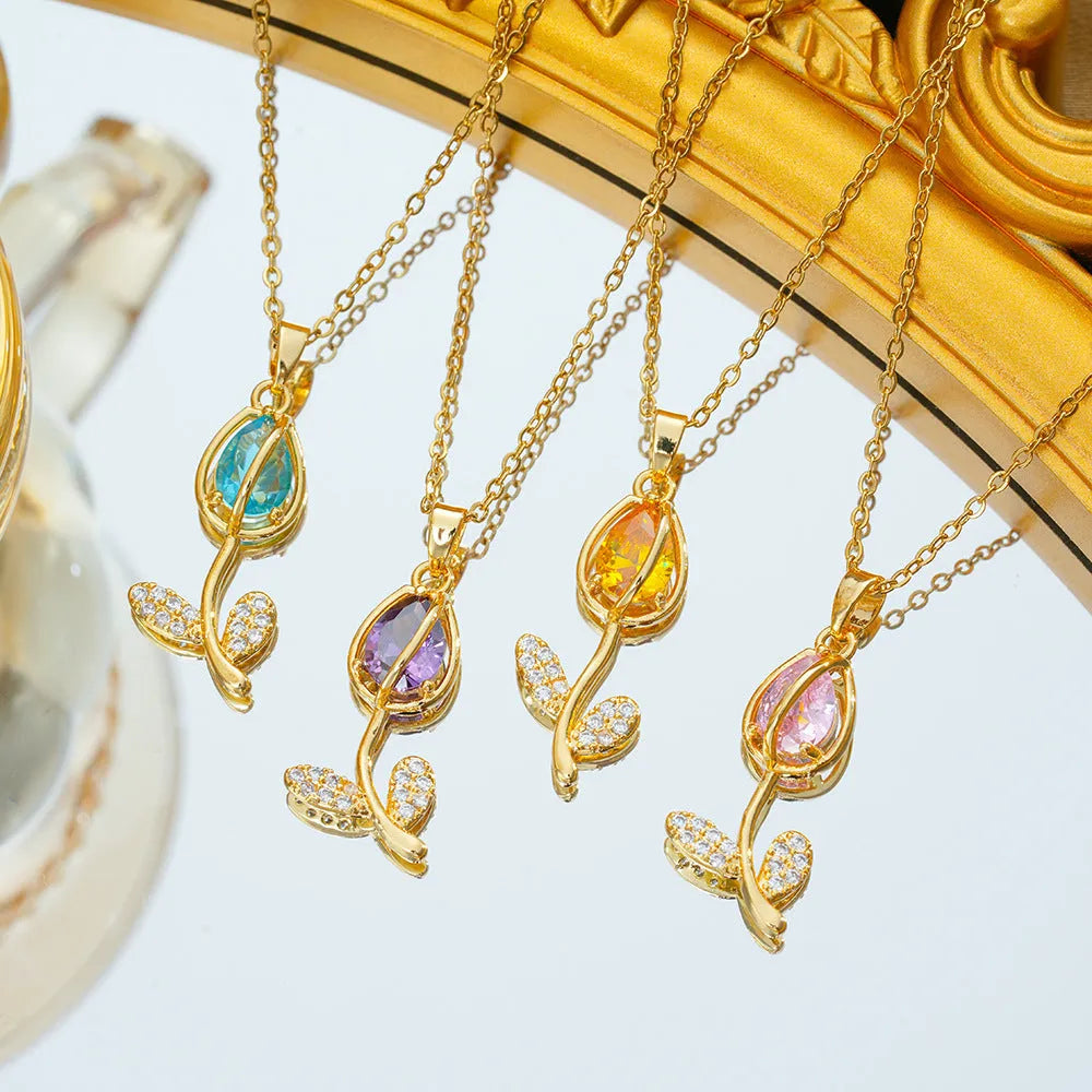Gold tulip flower pendant necklace on an adjustable O-ring chain, showing electroplated finish.